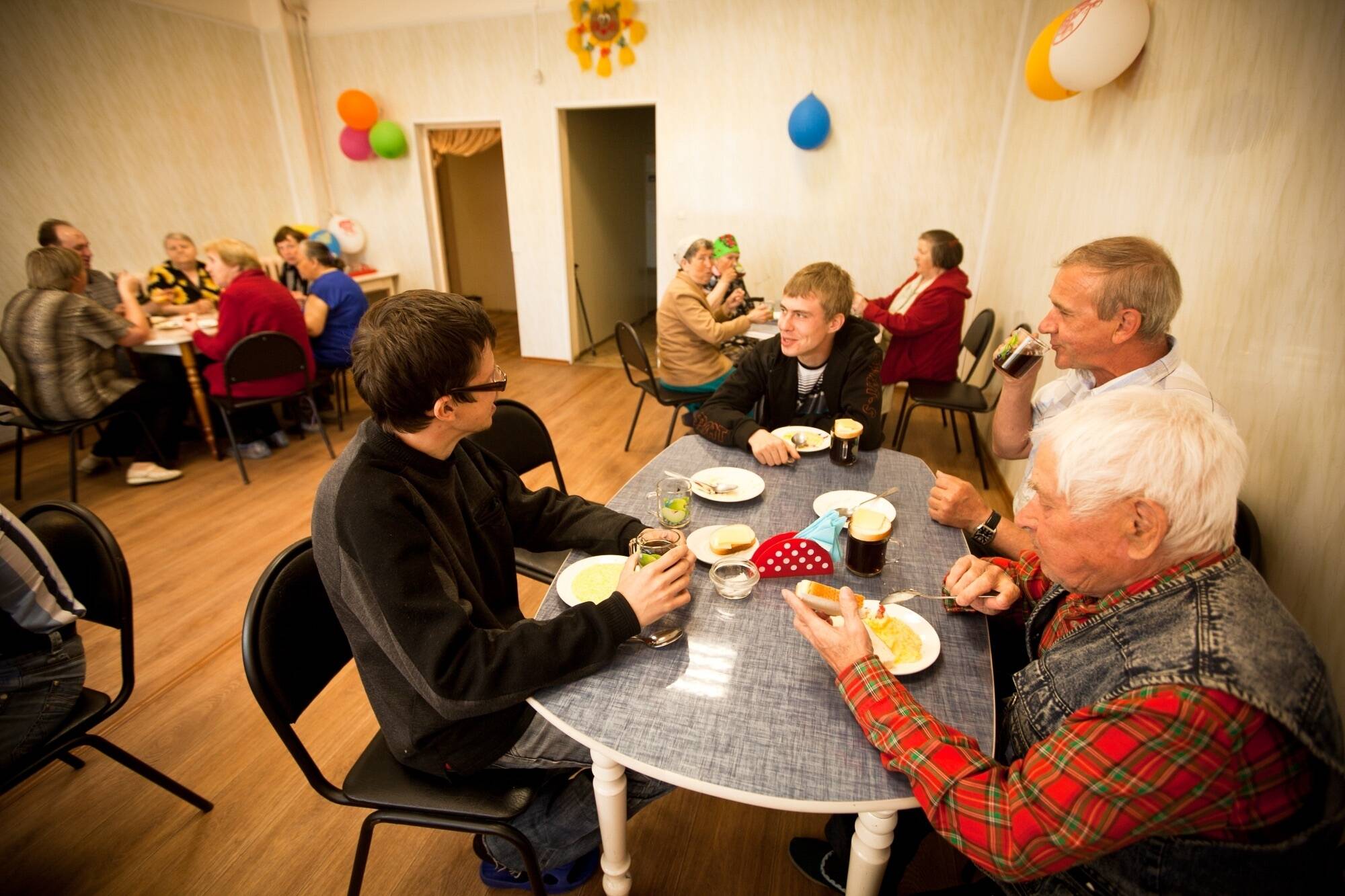 Old people having lunch volunteering editorial use only