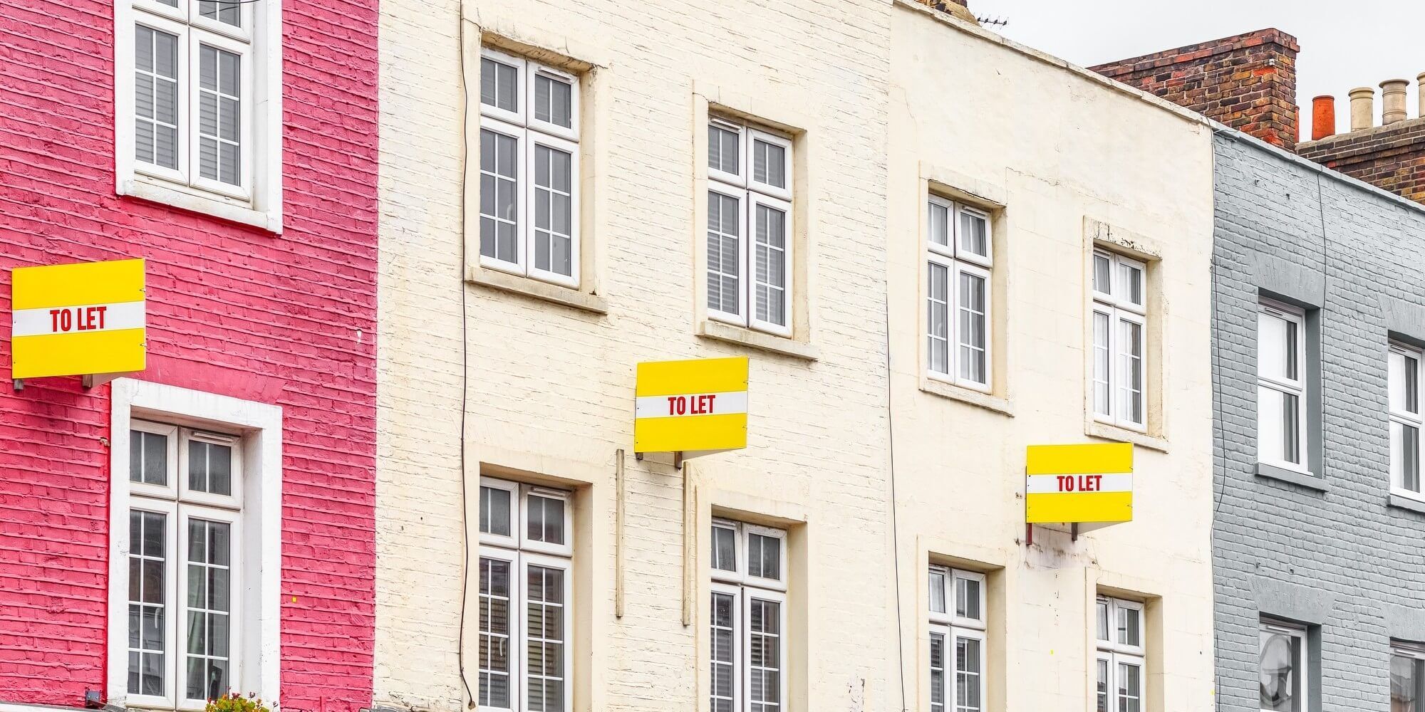 Colourful terraced houses with to let sign in Camden London