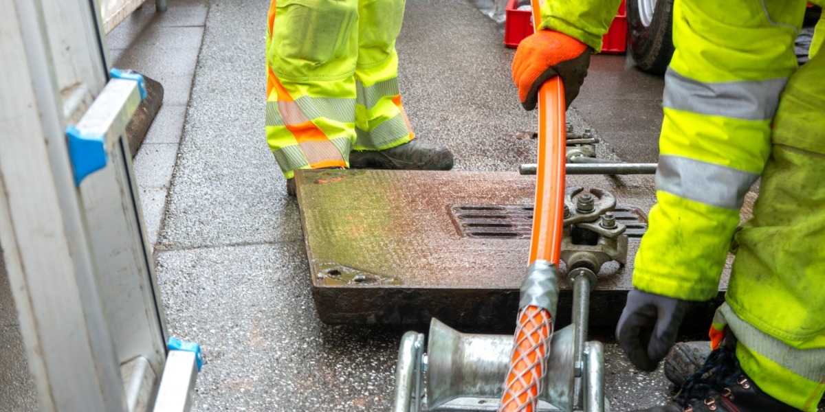 Workers lay a new Internet fiber optic cable